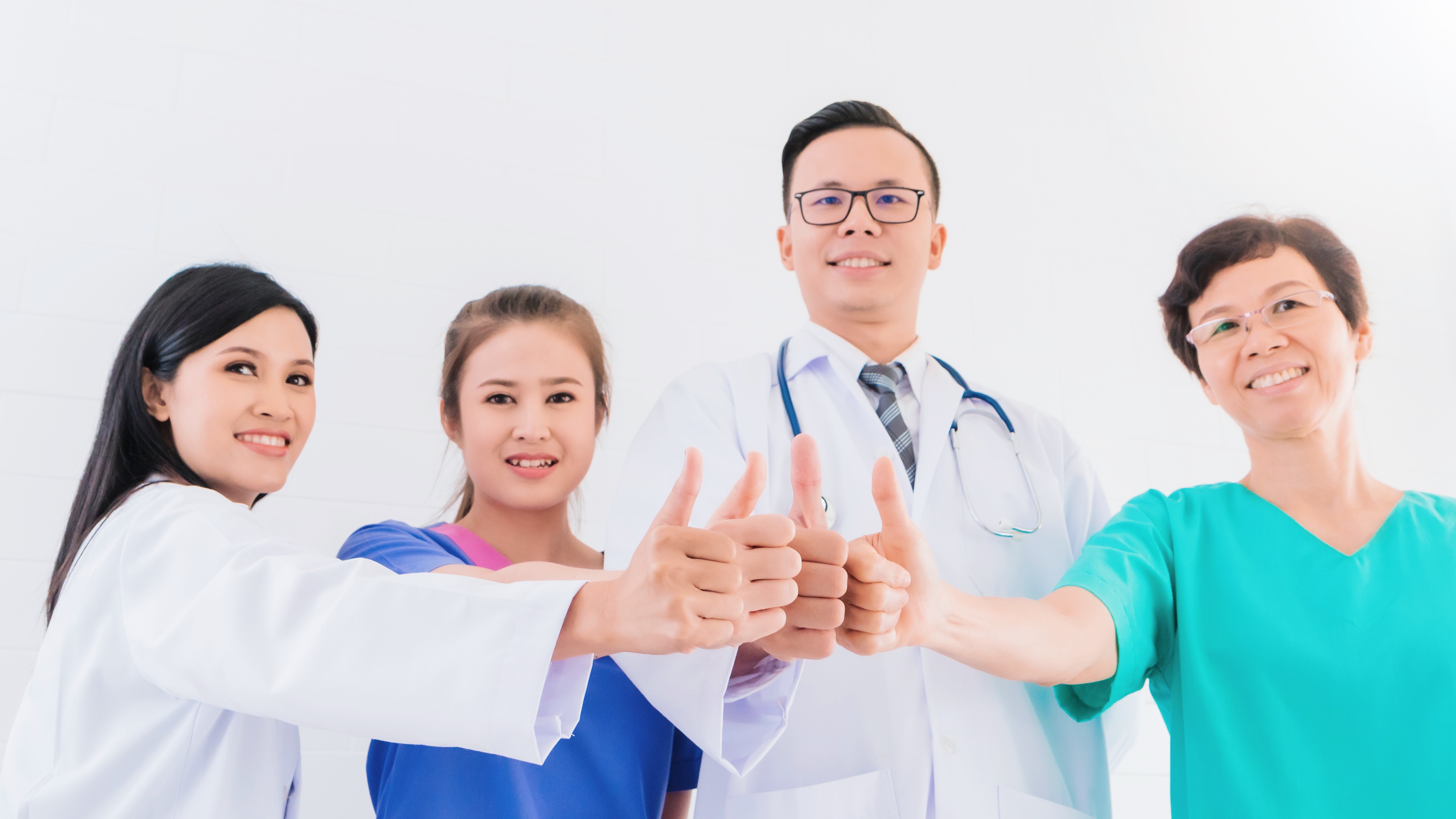 portrait-smiling-asian-medical-male-doctor-standing-showing-hand-thumb-up-with-team-staff-hospital.jpg