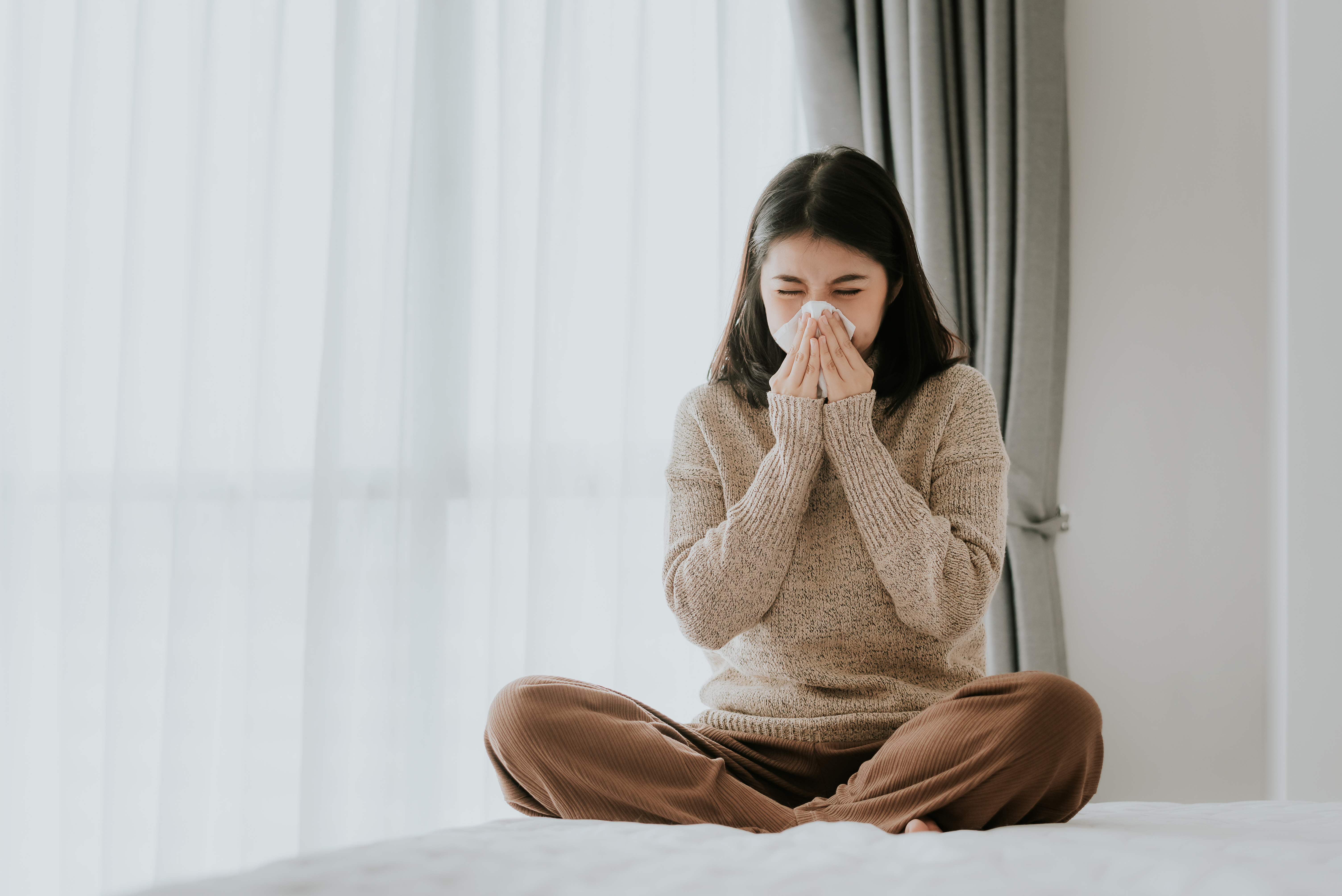 sick-asian-woman-using-tissue-sneeze-home.jpg